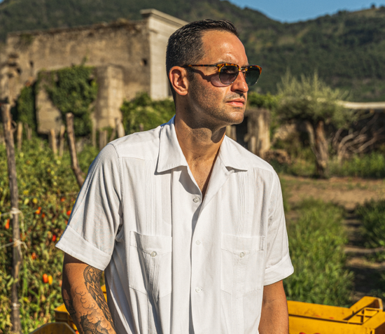 Chef Mario Carbone overseeing the fields of Italy where tomatoes are grown for Carbone Fine Food sauces. 100% imported Italian tomatoes.